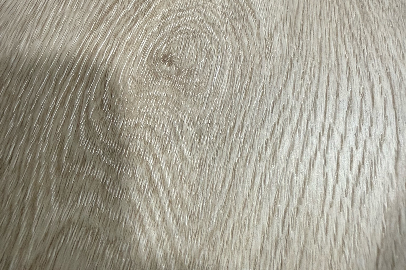 Close photograph of grain and embossed texture on a flooring surface