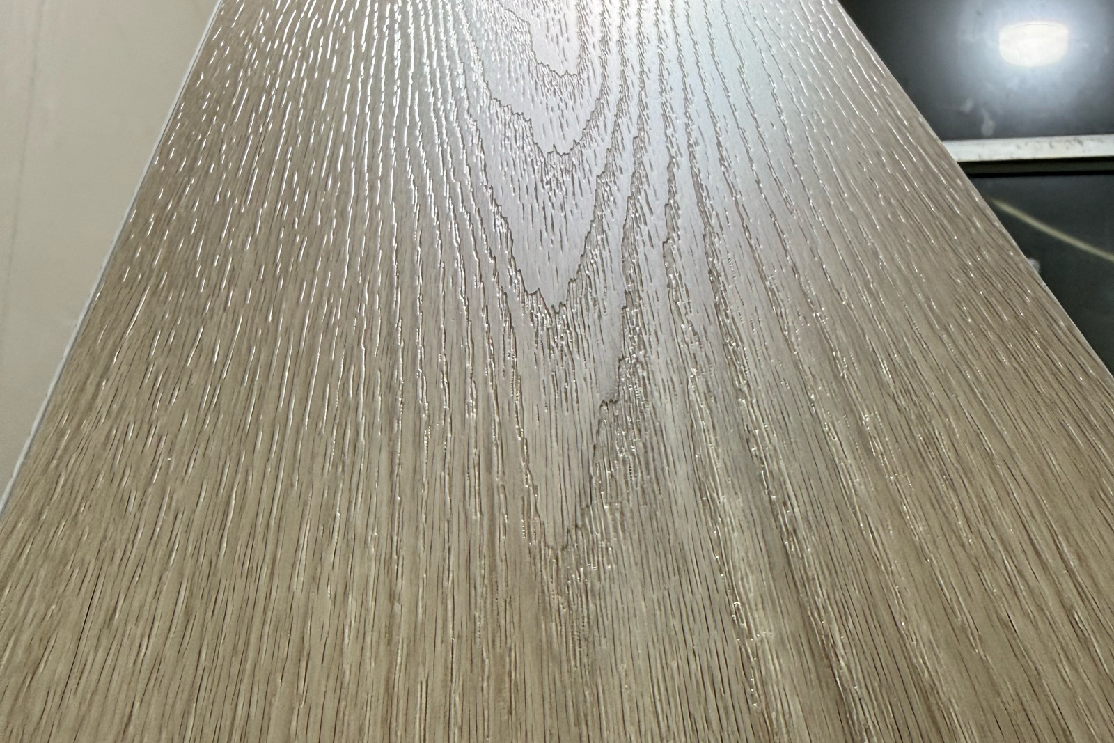 Photograph of flooring grain and surface texture under raking light